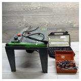 Router with router table and assorted bits.