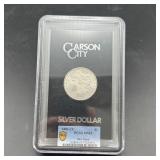1883-CC Morgan silver dollar, graded MS-63.