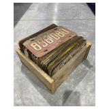 Wooden box and plastic crate of license plates