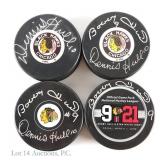 Bobby Hull & Dennis Hull Signed Pucks (4)