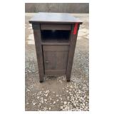 Dark wood side table with lower cabinet door and