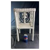 White wicker plant stand featuring a woven