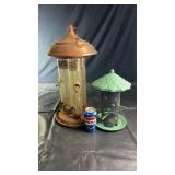 Pair of bird feeders including a larger metal and