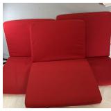 Set of three red seat cushions with removable