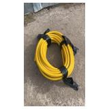 Coiled yellow flexible hose, durable heavy-duty