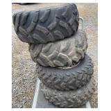 Set of four Titan ATV tires mounted on metal