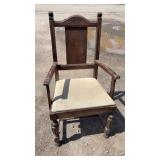 Vintage wooden arm chair featuring a high