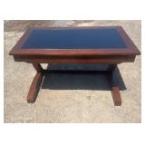 Wood coffee table with a dark inset top and