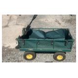Green metal garden utility wagon with four