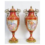 Pair of French porcelain rouge scenic urns