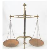 An antique brass balance scale