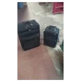 2 suit cases 1 large and 1 medium black in color