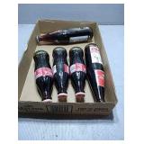 Flat with 5 full coke bottles