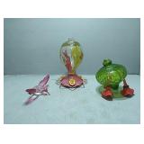 Hummingbird feeders and a glass humming bird