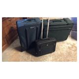 Green snd black luggage on wheels
