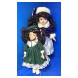 2 brown hair porcelain dolls. One stand
