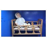 Vintage doll in crib. Some damage