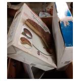 Box with springform pan, cooling rack, and cake