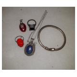 2 rings, heart bracelet, and a blue necklace