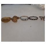 5 rings from L to R sizes 7, 8, 8, 8.5, 8