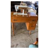 Singer sewing machine in cabinet