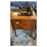 Singer sewing machine in cabinet