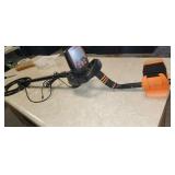 Metal detector in case with shovel