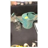 Watering can and glass bottle