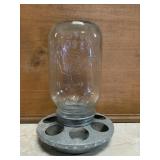 Momï¿½s mason jar with chicken feeder lid