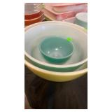 Three Pyrex bowls large and small bowl are in