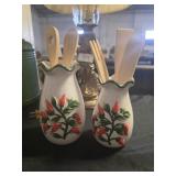A pair of kitchen vases with wooden utensils
