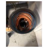 Trash can full of extensions cords