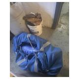 Bucket full of baseball gloves and catchers gear