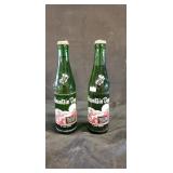 Two vintage full mountain dew bottles