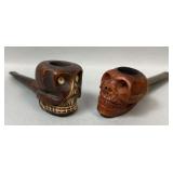 Two Carved Skull Smoking Pipes