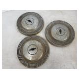 Three Chevy hub caps