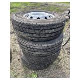 Stack of LT225/75R16 tires on rims (4)