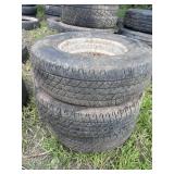 Stack of P235/75R15 tires (3), one on rim