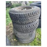 Stack of LT235/75R15 tires on rims (4)