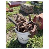 Bucket of horse shoes, blades, other