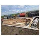 Pile of lumber, posts, and tin