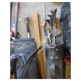 assorted misc golf clubs in bags
