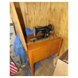vintage Universal sewing machine in cabinet