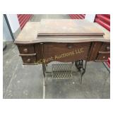 antique White sewing machine in cabinet