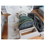 palm  sander in case extra sanding pads