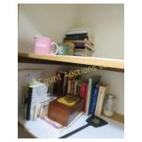 all on top 2 shelves left cook books mugs