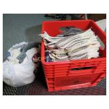 huge amount new gloves in milk crate