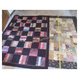 2 hand made quilts smaller end of bed table