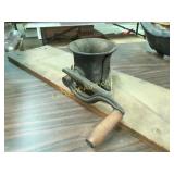 vintage meat grider stuffer mounted on board