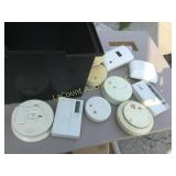 assorted smoke detectors programmable thermostats